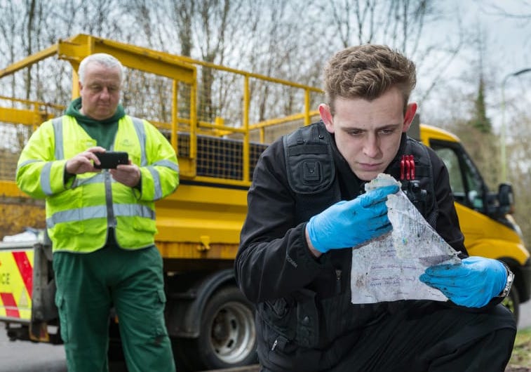 officer-searching-through-fly-tip.jpg